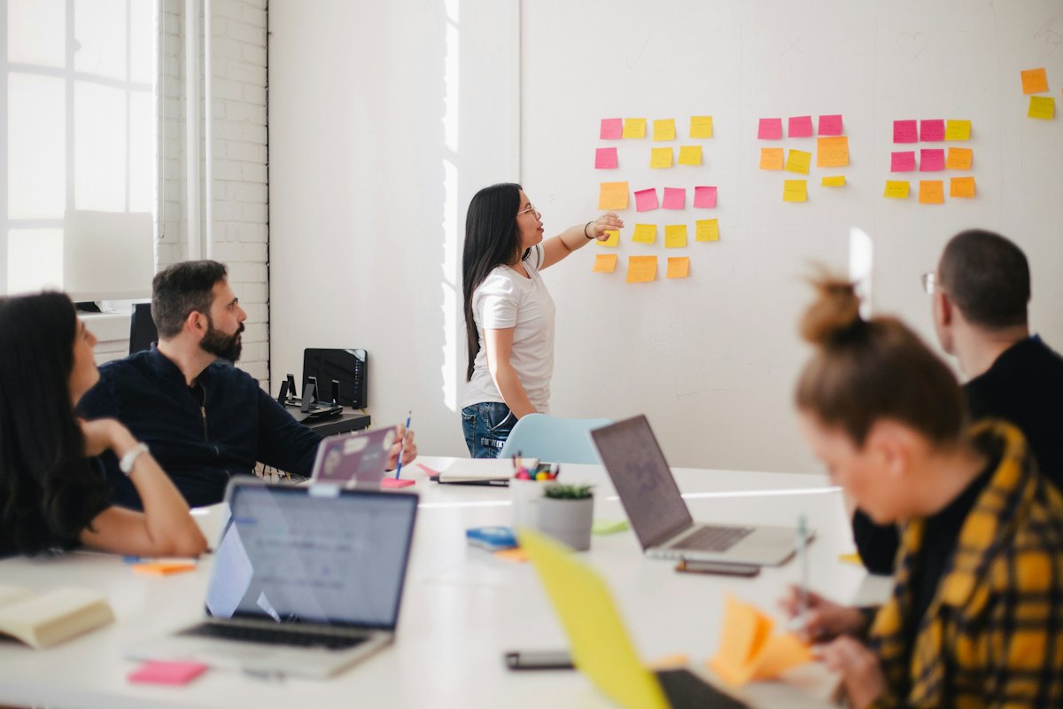 Team mapping processes with sticky notes in a workshop